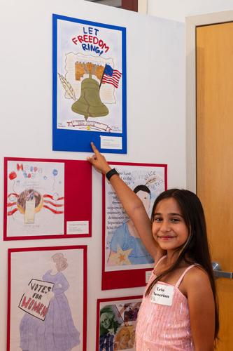 Leia Nasserian points to her entry, which received special recognition for poster design. Courtesy of Ann Hepenstal